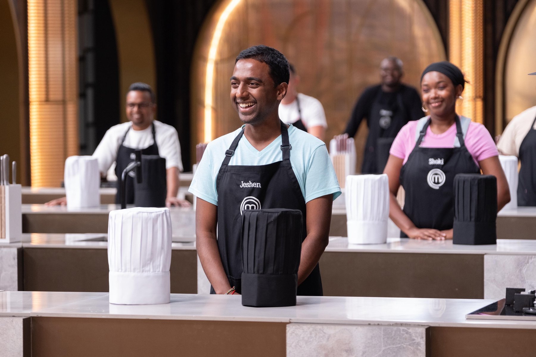 Jeshen Govender smiling in the MasterChef kitchen